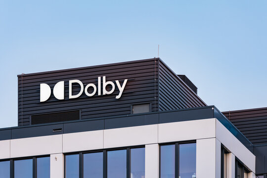 Wroclaw, Poland - March 27 2025: Dolby Company Logo on Modern Glass Office Building in Wroclaw Poland at Sunset Contemporary Corporate Architecture and Branding in Golden Hour Urban District