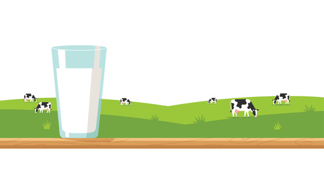 A tall glass of fresh white milk rests on a smooth wooden surface while black and white cows graze peacefully in the distant green pastures under a clear sky.