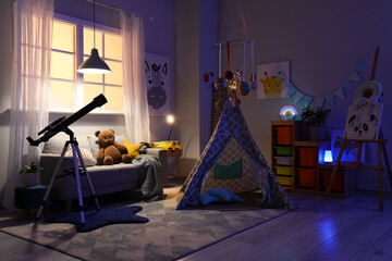 Interior of children's room with telescope, sofa, play tent and glowing lamps at night © Pixel-Shot