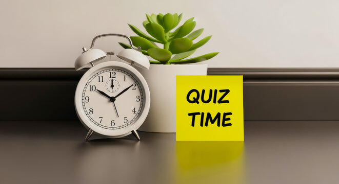 White alarm clock with yellow note reading quiz time next to succulent