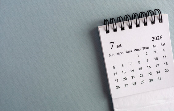 Desktop calendar for July 2026 on the desk.