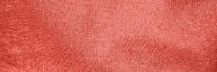 Fototapeta premium Fabric with textured pattern in warm coral shade creating a cozy and inviting atmosphere in a soft setting