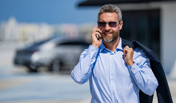 Mature Hispanic businessman with phone. Business communication. Negotiation online. Businessman talking on phone outdoor. Businessman reply on business call. Man phone conversation. Copy space