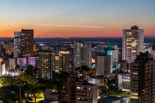 Moinhos de Vento neighborhood at sunset and first night lights and airplane lights