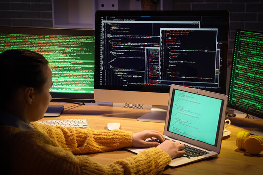 Female programmer working in office at night