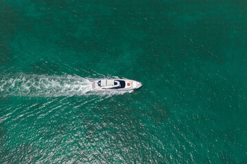 Fototapeta premium Yacht boat tour. Luxury boat yachting. Motorboat sailing at sea. Luxury charter yacht in sea. Motor yacht luxury vessel. Sea motor boat. Sea summer vacation. Aerial motorboat. Miami vibes