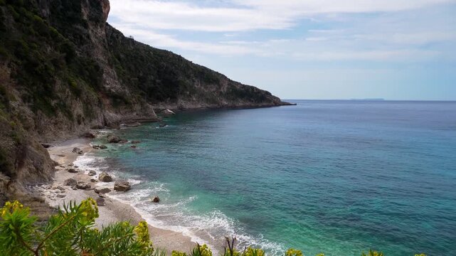 Aerial view hiking viewpoint spot isolated Filikuri beach in spring. Clear turquoise Ionian sea meets steep rocky coastal cliffs. Scenic Albanian Riviera travel landscape in Himar&euml;, Albania.