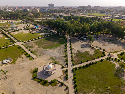 Aerial view of Rani Bagh park featuring a white domed pavilion, paved walkways lined with manicured hedges, and lush green lawns in Hyderabad, Sindh, Pakistan.