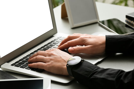 Young female programmer working with laptop in office, closeup