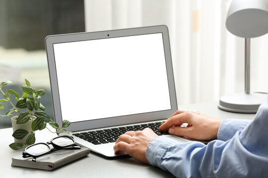 Young female programmer working with laptop in office, closeup
