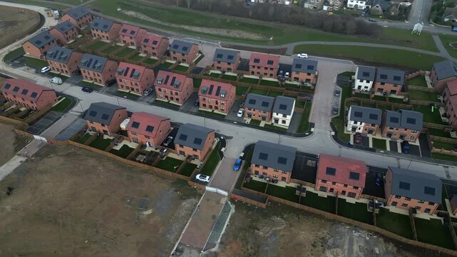 New houses built in residential area with roads and empty fields nearby at Taylor Wimpey, Ripon, UK.