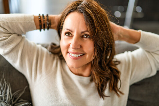 Beautiful aging. Portrait pretty mature female pensioner sit on sofa