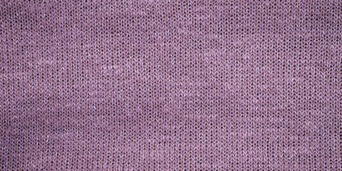 Fototapeta premium Knit fabric in soft purple color displayed on a flat surface during the day