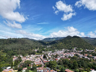aerial view of colorful rooftops on colonial buildings in downtown antigua guatemala drone footage volcano cobblestone spanish style architecture streets looking down © Yuriy T