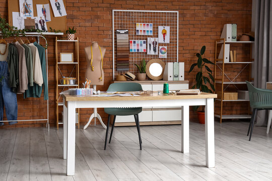 Interior of fashion designer's studio with workplace, mannequin and pin board