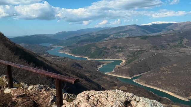 Rugged stone rises from earthy ground. Kozji Kamen viewpoint. Stara Planina, Serbia.