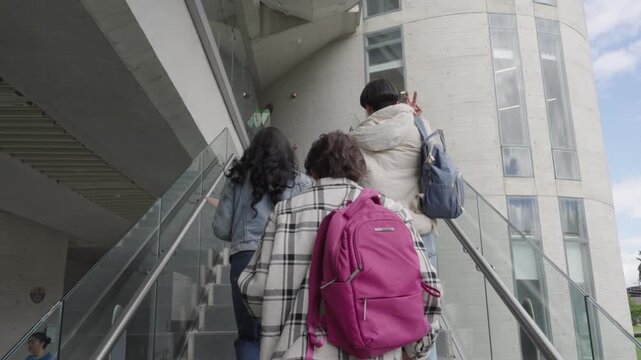Group of diverse college students walking up stairs
