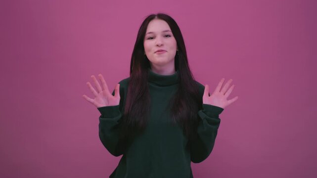 Portrait: teenage girl millennial shows vivid emotions, expresses wow surprise. Young woman with long dark hair raises hands, Great New, junior kid. New generation Z, amazement wonder. Slow motion