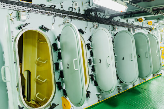 Open crankcase doors of a massive marine main engine during inspection.