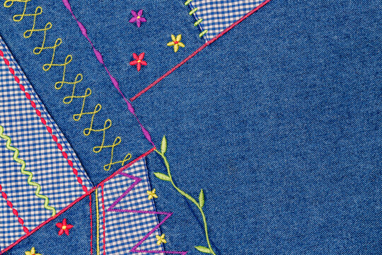 Inspirational quilt design showing colorful stitching patterns on denim fabric during daylight hours