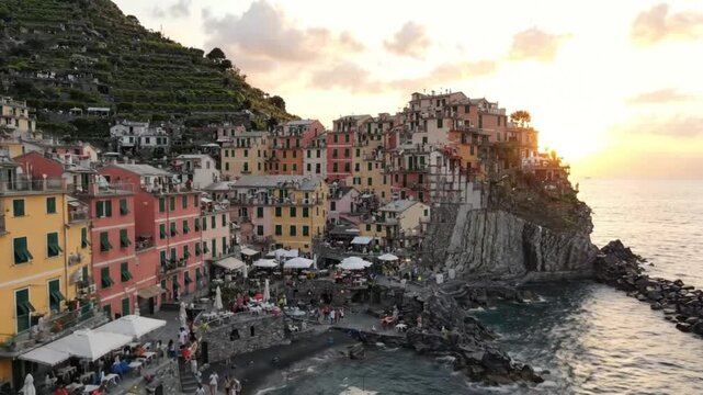 Colorful coastal village at sunset with dramatic cliffs and seaside buildings in Cinque Terre Italy scenic travel destination landscape