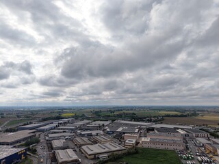 Obraz premium Aerial View of a Industrial Estate: A comprehensive view of an industrial estate sprawling across the landscape, captured from an elevated perspective under a dramatic sky.