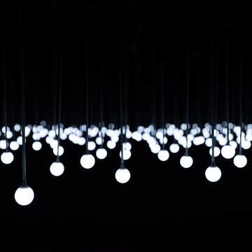Abstract composition of glowing white orbs hanging from thin wires in darkness, emphasizing minimalist design and luminous texture, decoration, orb, chandelier