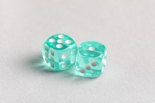 Turquoise game dices on grey background