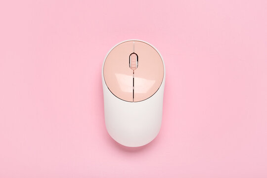 Modern wireless computer mouse on pink background