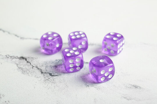 Purple dices on light background