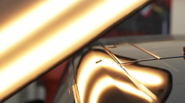 Paintless dent repair requires a dynamic slide hammer to pull glued tabs outward 4k video.