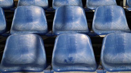 Fototapeta premium Rows of Empty Blue Plastic Stadium Seats at a Sports Arena or Outdoor Venue