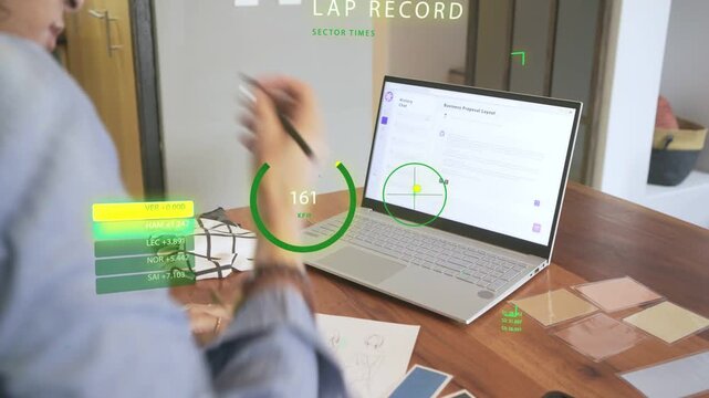 Nonbinary designer gesturing at laptop pointing stylus drawing while AR HUD LAP RECORD timing