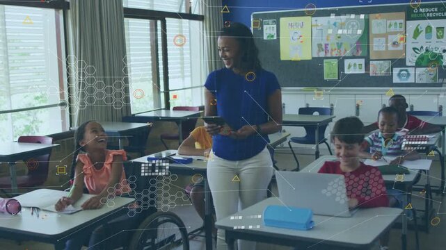 Teacher moving through classroom, tapping tablet causing AR hexagons over laptop, engaging class