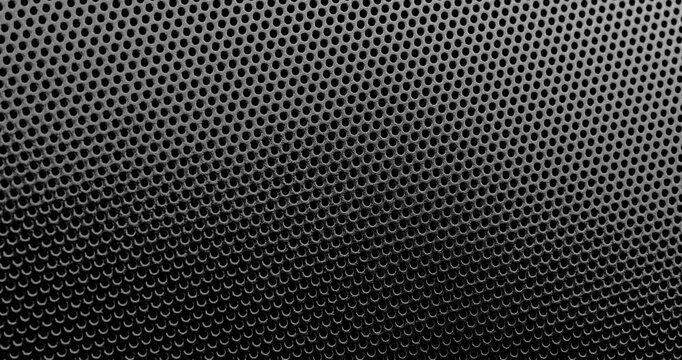 Perforated surface texture. Black perforated surface with a repeating hole pattern, creating a textured and industrial look.