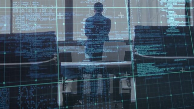 Executive standing at table, sequence starting, code HUD scrolling across him while checking laptop