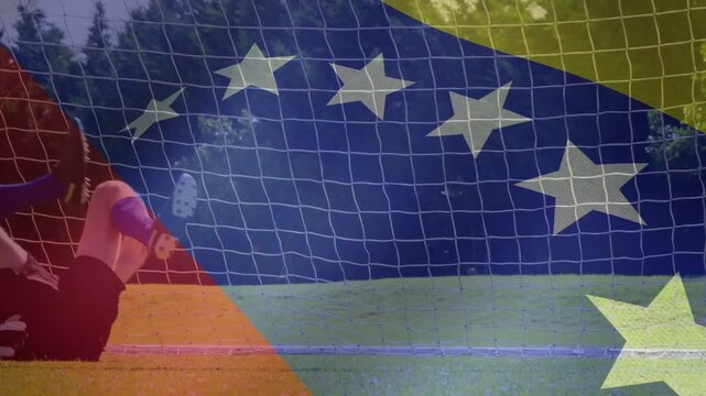 Soccer ball approaching GK shifting diving and deflecting saving goal flag overlay obscuring action