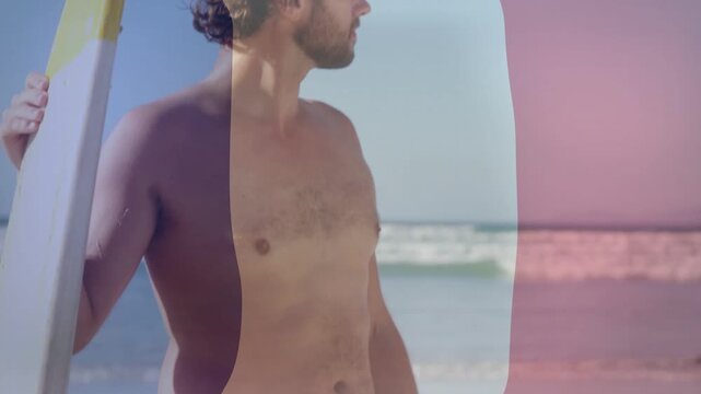 Surfer holding board, camera rising, tricolor wash sweeping over him, scouting waves for travel