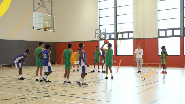 Sports teams lining free-throw lane, shooter receiving ball releasing shot to score, arc tracing