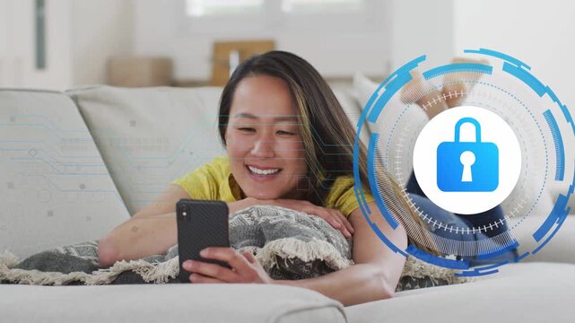 Mid-adult woman lying on sofa with phone, waving after lock HUD overlaying face joining secure call