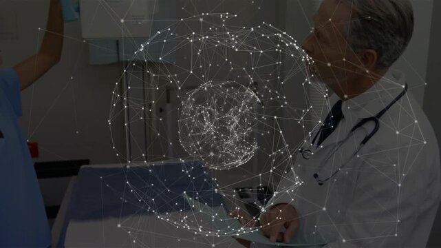 Nurse raising arm toward panel turning on holo sphere while doctor reviewing chart for medical scan