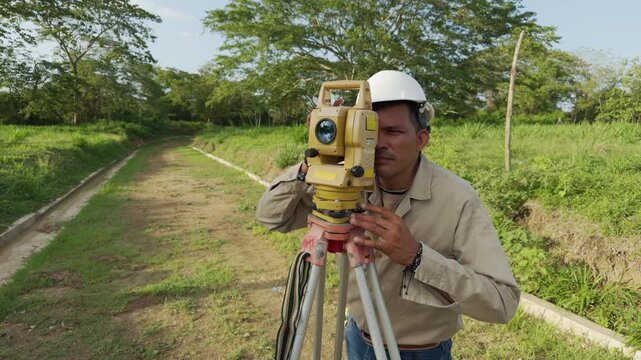 Surveyor engineer using theodolite total station equipment