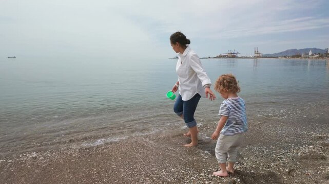 Mother And Child Enjoying A Peaceful Day On The Beach In Malaga, Spain