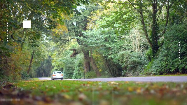 Silver car entering from right, crossing road and receding, with animated overlays for auto design