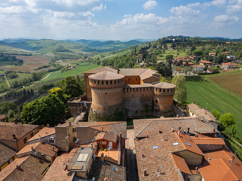 Italy, 10 April 2026: Aerial drone view of Dozza medieval village in Emilia Romagna, featuring the historic Rocca Sforzesca fortress, colorful murals, tiled rooftops, and scenic Italian countryside la