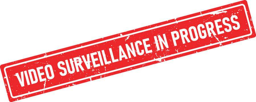 A red rectangular rubber stamp impression displaying the notice VIDEO SURVEILLANCE IN PROGRESS with grunge distressed texture