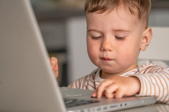 Kid using computer at home, concept of screen dependency and behavior patterns.