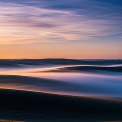 Fototapeta premium Ethereal morning mist settles low over expansive, rolling prairie landscape, creating a dramatic, cool, and mysterious natural scene, silence, land, dramatic