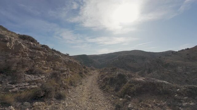 First person view walking on a mountain trail path