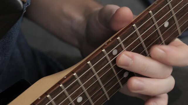 Playing electric guitar fretboard closeup. High quality 4k footage